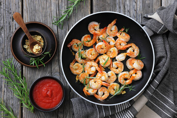 rosemary and garlic seared shrimps in a skillet