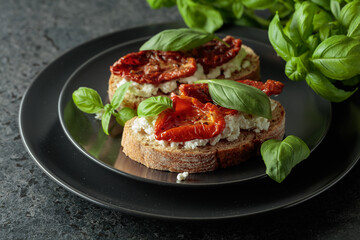Tasty ciabatta with sun dried tomatoes in olive oil, ricotta and basil.