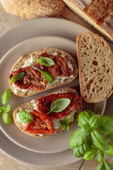 Ciabatta with sun dried tomatoes in olive oil, creamy cheese, and basil.