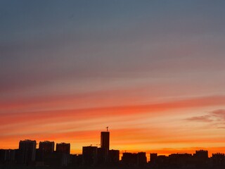 Fototapeta premium Silhouette of the tower crane on the construction site with city building background