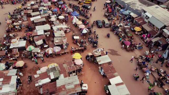 Agege, Nigeria - 26 July 2025: Aerial view of a bustling Akute - Ajuwon Road market, with colorful umbrellas and diverse buildings creating a vibrant scene.