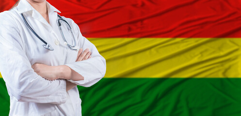 Doctor with crossed arms on Bolivia flag. Bolivia health and care concept. Female doctor on Bolivia...
