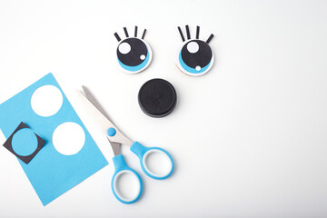 Creative handmade face using paper cutouts and recycled materials, perfect for children crafts, eco-friendly branding, preschool activities, art education content,