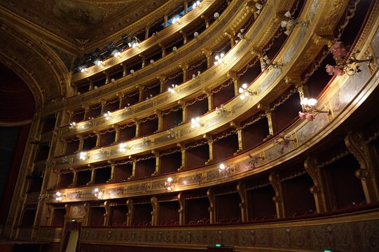 Curved tiers of ornate, golden boxes inside the opulent auditorium of the Teatro Massimo opera house in Palermo, Sicily