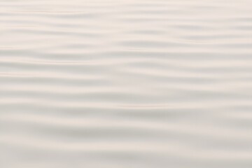 Obraz premium Close-up of still water with smooth ripples—evoking peace, introspection, and minimalist beauty through natural light and texture.