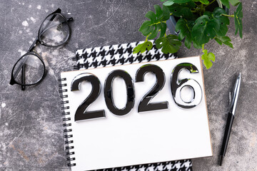 New year resolutions 2026 on desk. 2026 goals list with notebook, plant on colorful background. Resolutions, plan, goals, action, checklist, idea concept. New Year 2026 resolutions, copy space