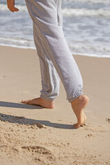 Close-up of legs walking on the seashore. High quality photo
