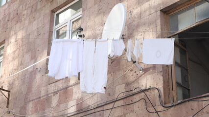 White Laundry Hanging on Tuff Stone Wall