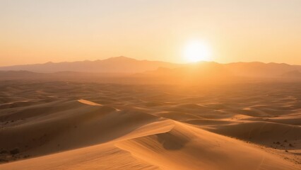 Sunset over vast sand dunes in a desert landscape with distant mountains