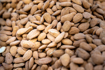 Roasted, unshelled almond nut seeds. Top view. 