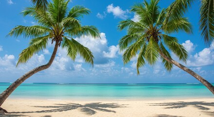 Obraz premium Idyllic tropical paradise with two coconut palm trees framing a serene view of the turquoise sea and white sandy shore