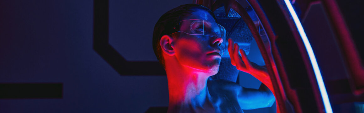 Tall alien explores advanced science lab filled with colorful lights and futuristic equipment