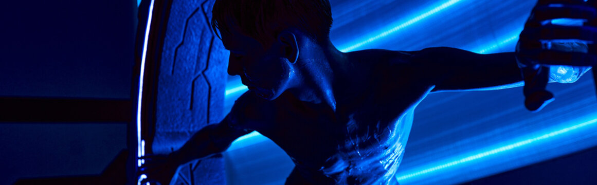 Mysterious alien presence in a futuristic science lab full of glowing technology