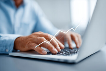 Professional man using laptop with holographic business graphs