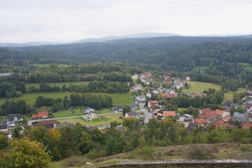 Ancient castle ruins overlooking picturesque village in bavarian forest
