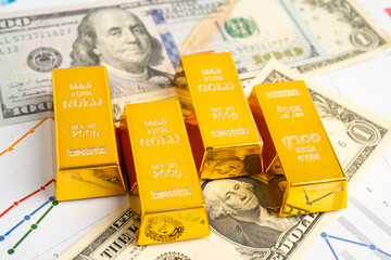Gold bars on US dollar banknote money, finance trading investment business currency.