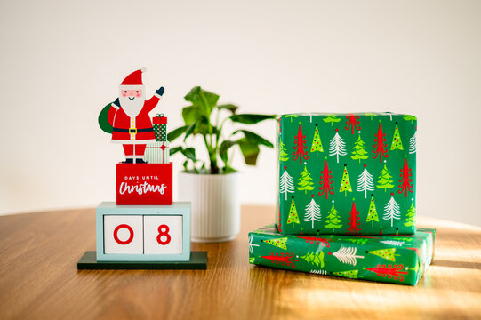 Wrapped gifts and a Santa countdown calendar show eight days till Christmas