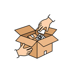 Two hands are placing items into an open cardboard box, one hand placing a small white package and the other holding a blister pack of pills.