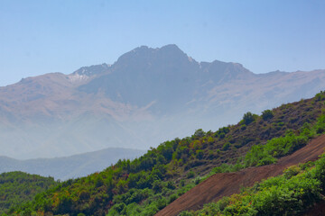 Beautiful mountain. High mountains and forests. Landscape with mountains, forests, and fields