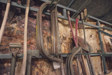 Tools hanging on a rock wall in a shelter