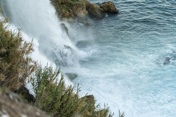 Waterfall Flowing Into the Ocean Over Rocks