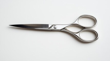 Obraz premium Sharp stainless steel scissors resting on a white background showcasing sleek design and functionality