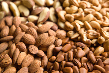 Close up of mixed nuts background. Healthy food and nutrition concept.