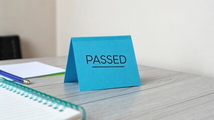 Blue note card with the word Passed displayed on a table