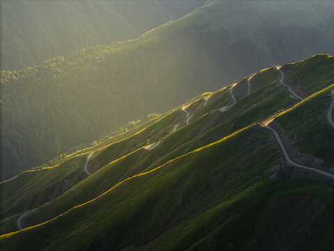 Aerial view of the winding Alazani pass road snaking through the verdant, sun-kissed mountains of Kakheti, Georgia, Chala, Kakheti, Georgia.