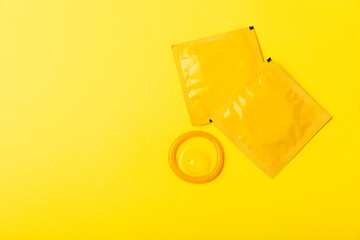 Condoms on a colored background. Colorful fruit-themed condoms in packaging. Safe sex concept. Contraceptive. Different birth control methods. Aids prevention. World AIDS Day. Sexual health.