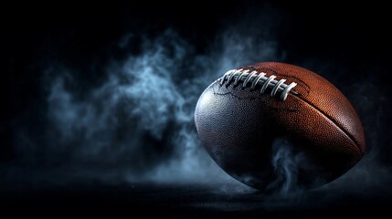 Football resting on a dark surface with smoke in the background, highlighting its texture and design