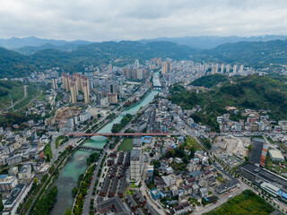 Xuan'en County Hubei Province China city unfolds with winding river through green hills and dense...