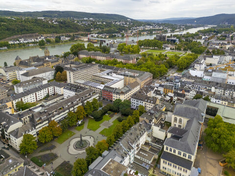 Aerial view of the Deutsches Eck where the Mosel joins the Rhine, a vibrant tapestry of architectural styles meeting the natural beauty of the riverbanks, Koblenz, Rhineland-Palatinate, Germany.