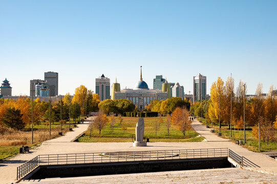 Astana Kazakhstan presidential park with autumn trees and view of Ak Orda palace and modern city skyline