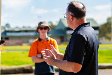 middle aged man talking to young trade apprentices