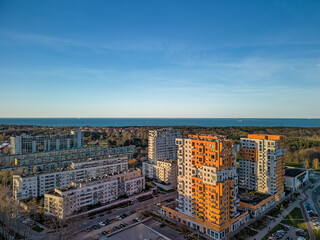 Fototapeta premium Wide aerial HDR panorama of Przymorze residential blocks and Baltic coast in Gdansk during late afternoon emphasizing urban layout