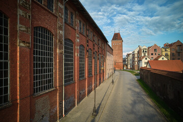 Industrial brick building corridor perspective with arched windows geometric architecture repetitive facade pattern urban infrastructure aerial