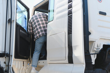 Truck driver entering cabin starting journey