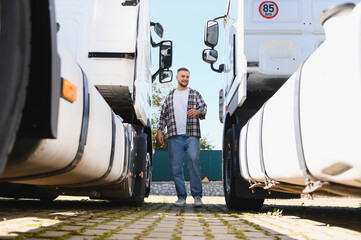 Truck driver walking between semi trucks
