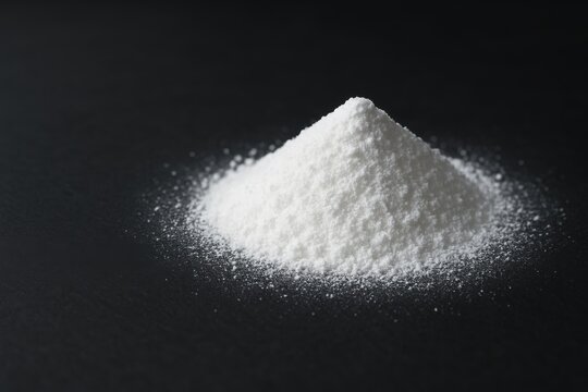 Fine white yttrium oxide powder with soft sparkle texture on a dark surface