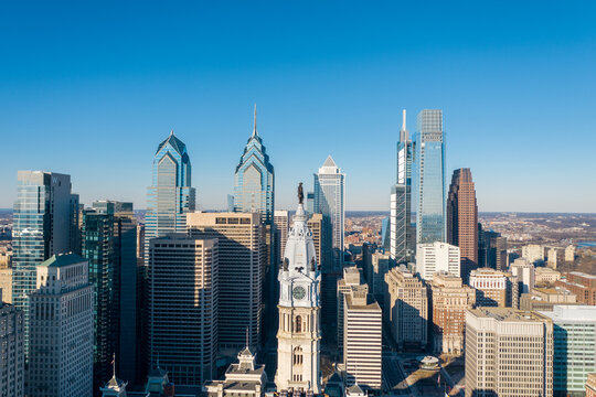 Aerial view of a skyline punctuated by the iconic Comcast Center and Liberty Place, where glass and steel reflect the crisp winter light, Philadelphia, Pennsylvania, United States.
