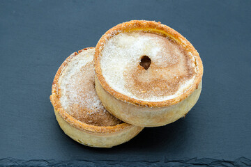 Two Steak Mince Pies one Resting on the other.