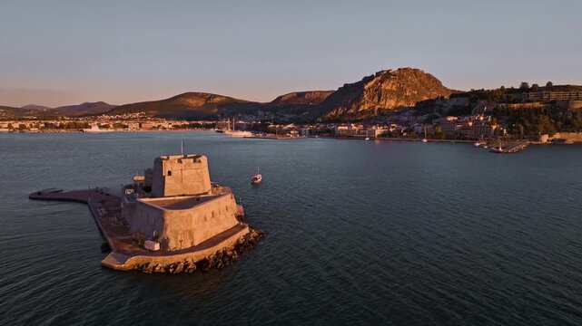 Aerial view of the Bourtzi castle and Palamidi mountain along the coast with the city visible in the background, Nafplion, Argolis, Greece.