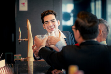 Celebrating success together friends raise their glasses in a joyous toast, sharing laughter and good times at a vibrant modern bar. This happy moment captures teamwork and friendship.
