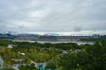 A grand dam stretches across the water, generating immense power with its vast structure.Three Gorges Dam, Yichang City.