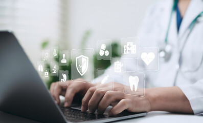 Doctor using laptop with digital healthcare icons representing medical technology innovation, data protection and online health services for modern hospital systems