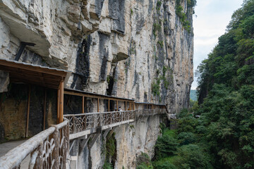 Enshi City, China, offers a walkway built into a sheer rock face overlooking a verdant gorge.