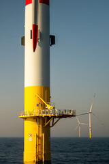 Offshore Wind Turbines at Sea. Renewable Energy Infrastructure and Sustainable Power Generation in Calm Ocean with Clear Sky