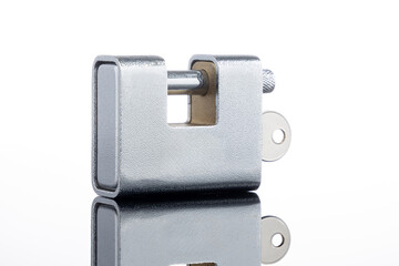 Heavy-duty chrome padlock with key, isolated on a white background with reflection. Concept for security, safety, access control, and protection.