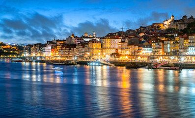 Panorama of the famous old town of Porto (Portugal) on the banks of the Douro River during the blue...